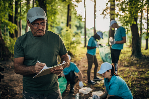 people outdoors in nature cleaning up rubbish