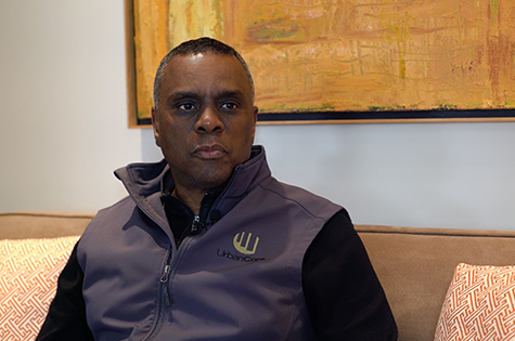 serious looking man sitting on couch