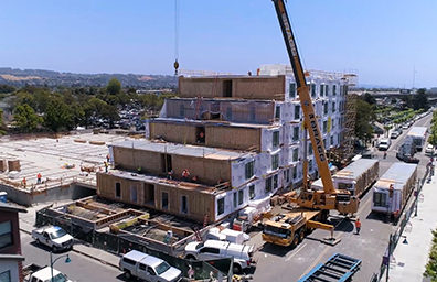 a crane next to a building being constructed