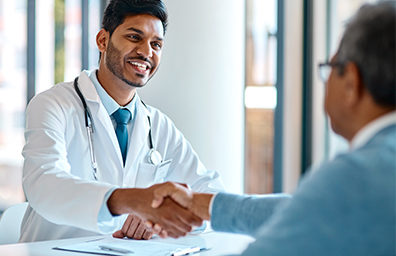 a doctor shaking hands with a patient