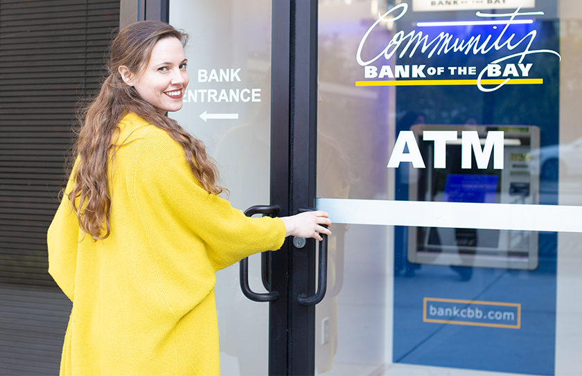 woman opening door to an enclosed ATM