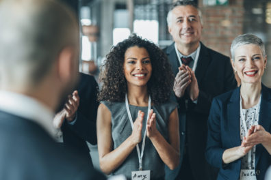 Corporate looking people celebrating and clapping