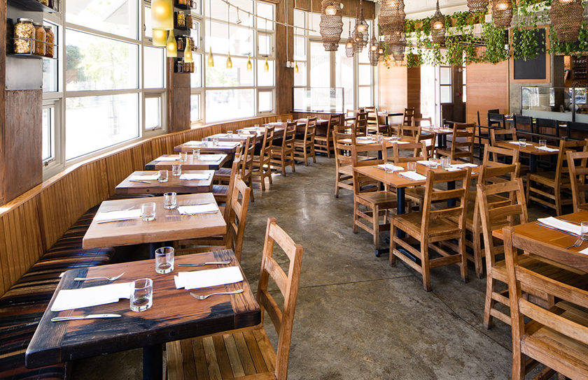 a restaurant interior with tables by window