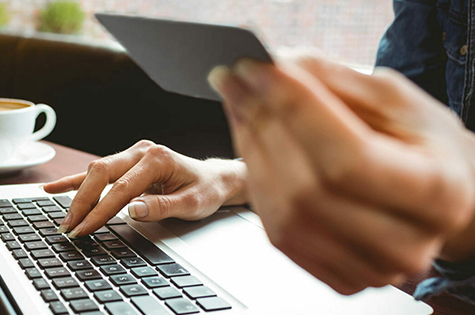 person with credit card and laptop